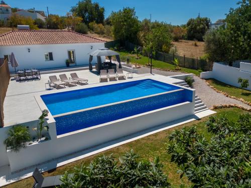 a villa with a swimming pool and a house at Casa Emella Luxury Villa Albufeira in Albufeira