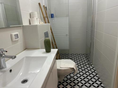 a bathroom with a white sink and a toilet at רגע של מדבר in Yeroẖam