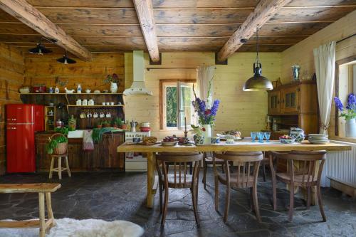 une cuisine avec une grande table et des chaises en bois dans l'établissement Bratkowa Chata, à Binczarowa