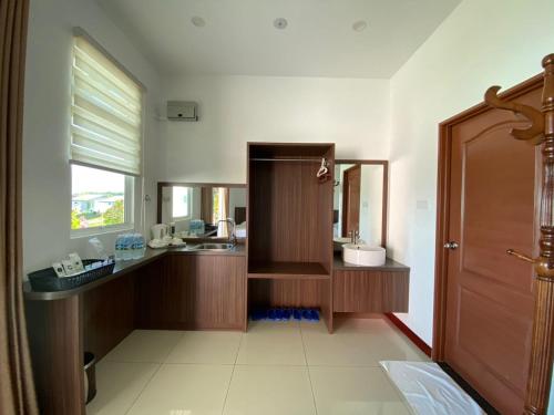 a bathroom with a sink and a mirror at D View Holiday Homes in Kudat