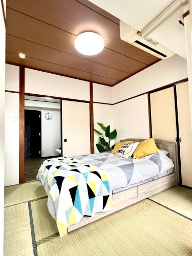 a bedroom with a large bed in a room at Hotel KinRin in Tokyo