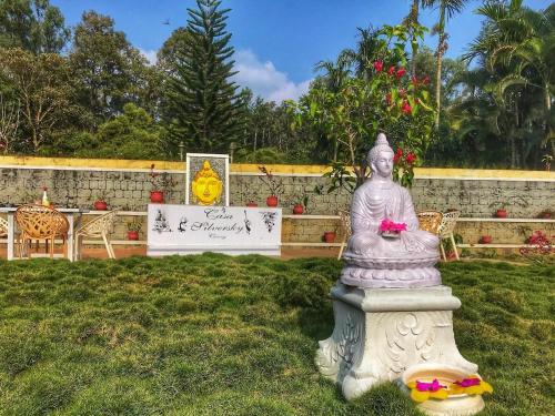 a statue sitting in the grass in a yard at Coomaaoon by silversky in Gonikoppal
