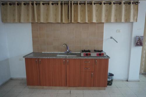 a kitchen with a sink and a counter top at Lovely Lama Family House in Bethlehem