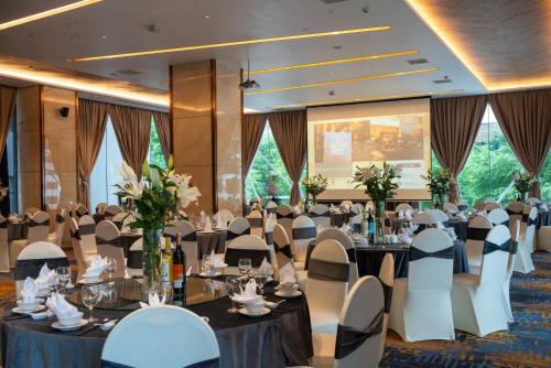a banquet hall with round tables and chairs at Northern Charm Hotel in Ho Chi Minh City