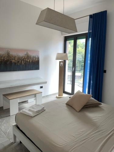 a bedroom with a bed and a large window at La Peonia in Castellammare di Stabia
