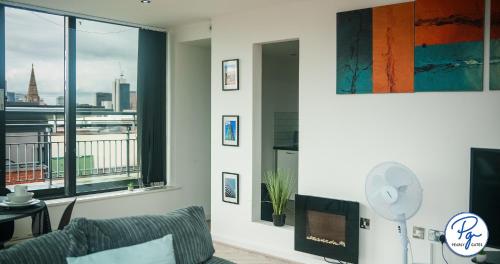 a living room with a couch and a large window at Penthouse - Amazing City Skyline Views - Free Parking - Balcony - Utilita Arena - New St Station - Bullring Shopping in Birmingham