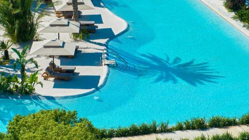an overhead view of a pool with chairs and umbrellas at Maxx Royal Belek Golf Resort in Belek