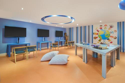 a room with a table and a blue wall at Maxx Royal Belek Golf Resort in Belek
