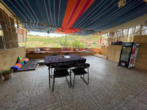 a patio with a table and chairs in a room at Hotel Shahiraj Jaisalmer in Jaisalmer