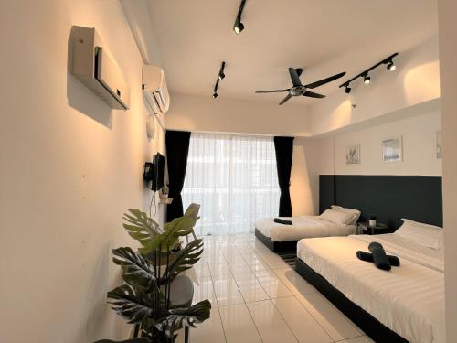 a bedroom with two beds and a ceiling fan at KASOTA SUITE Aeropod Sovo-Near KKCity-Near Airport in Tanjong Aru