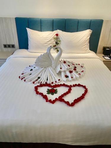 a swan made out of hearts on a bed at The Art Nest Hotel Nha Trang in Nha Trang
