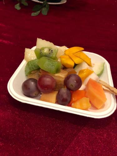 a plate of fruit and vegetables on a red table at Hotel Balgopal in Kathmandu