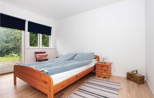 a bedroom with a bed and a large window at Beautiful Home In Grevinge With Wifi in Grevinge