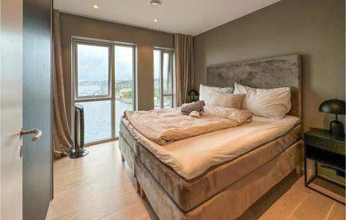 a bedroom with a bed with a stuffed animal on it at Amazing Apartment In Haugesund With Outdoor Swimming Pool, Wifi And 3 Bedrooms in Haugesund