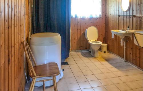 a bathroom with a toilet and a sink and a chair at Nice Home In Olden With 2 Bedrooms in Olden