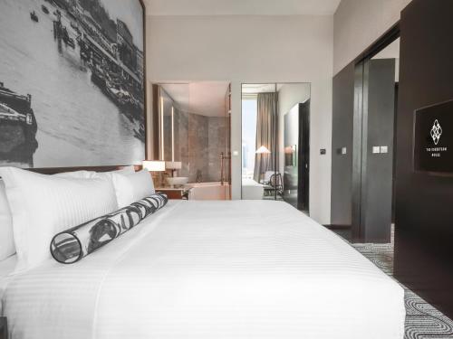 a large white bed in a hotel room at The Robertson House by The Crest Collection in Singapore