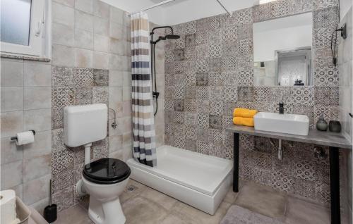 a bathroom with a toilet and a sink and a shower at Stunning Home In Karlobag With 2 Bedrooms And Wifi in Karlobag
