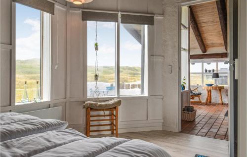 een slaapkamer met een raam en uitzicht op de oceaan bij 4 Bedroom Beach Front Home In Hvide Sande in Bjerregård