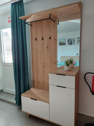 a room with a wooden cabinet and a dresser at Studio apartma Žirovnik in Cerklje na Gorenjskem