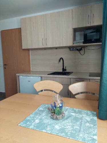a kitchen with a table with chairs and a bowl on it at Studio apartma Žirovnik in Cerklje na Gorenjskem