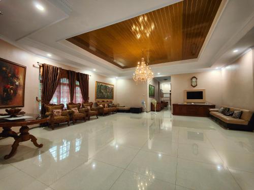 un grand salon avec un lustre dans l'établissement De Hanami Homestay Setrayasa, à Cirebon