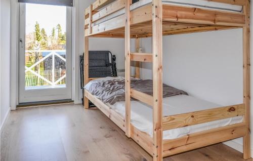 a bunk bed in a room with a window at Amazing Home In Hornbk With Wifi in Hornbæk