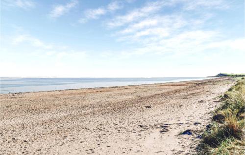 a sandy beach with the ocean in the background at Gorgeous Home In Grenaa With Kitchen in Brøndstrup