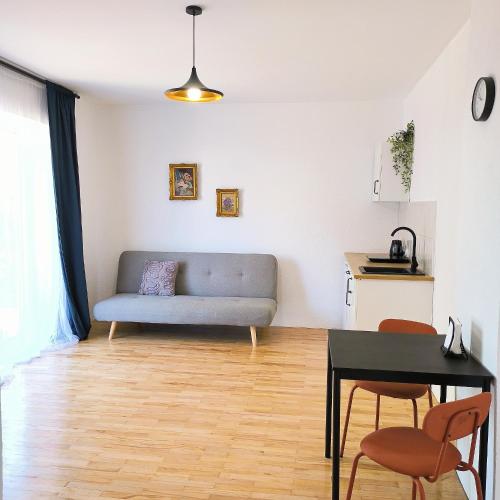 un soggiorno con un divano e un tavolo di GuestHouse Maison Comfort a Kula