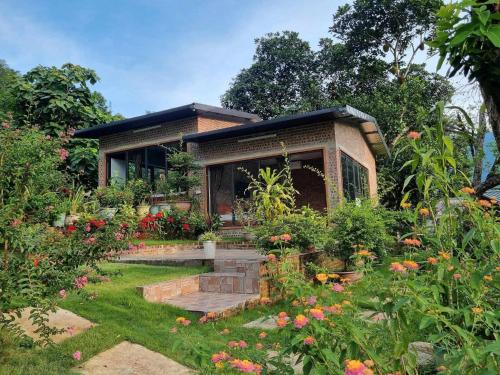 a small house with a garden in front of it at Trường Anh Homestay Hà Giang in Ha Giang