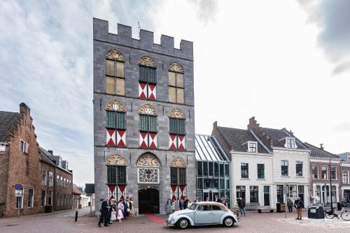 a building with a car parked in front of it at Luxurious and spacious apartment in historic building in Vianen
