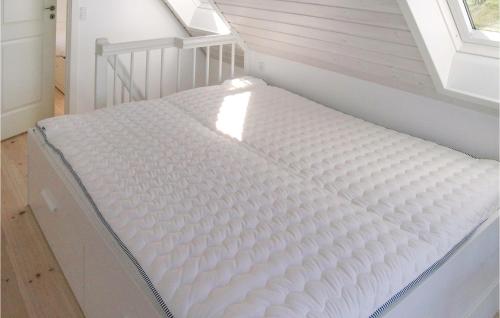 a mattress bed in a room with a window at Lovely Home In Strandby With Wifi in Strandby