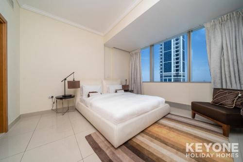 a bedroom with a large white bed and a window at Captivating Sea Views in Two Bedroom Apartment in Dubai