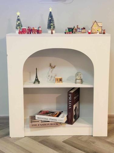 a white book shelf with books and christmas decorations at NK hostel 31 in Ban Bang Phang