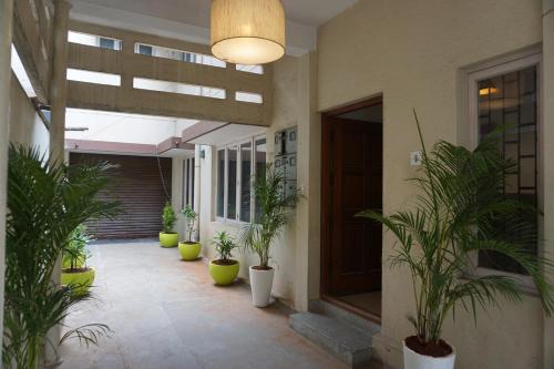 a courtyard with potted plants in a building at Snore Summore, Hostel in Koramangala in Bengaluru