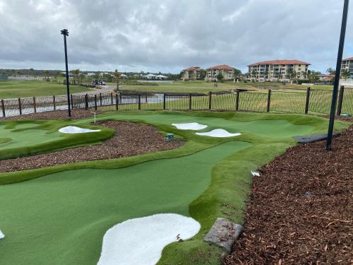 a golf course with several holes and a green at Resort One Bedroom Apartment in Pelican Waters