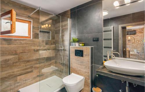 een badkamer met een toilet, een wastafel en een spiegel bij Beautiful Apartment In Mundanije With Kitchen in Mundanije