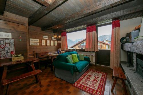 a living room with a couch and a table and a window at Arianna - Happy Rentals in Livigno