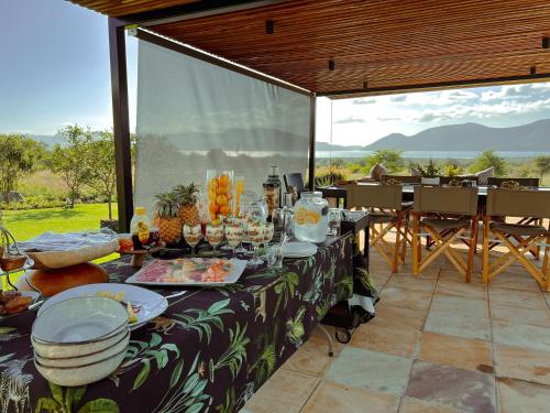 a table with food on it on a patio at Tandweni Villa in Pongola Game Reserve
