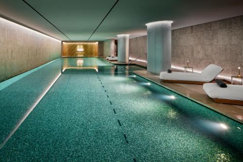 a swimming pool in a hotel room with a swimming pool at Bulgari Hotel Paris in Paris