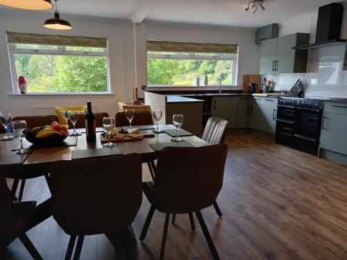 a kitchen and dining room with a table and chairs at Beech House in Fort William