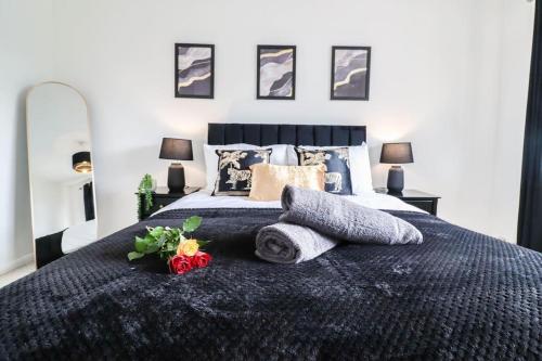 a bedroom with a bed with towels and flowers on it at Ted House - Long Stay Discount in Royal Tunbridge Wells