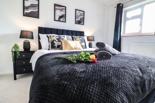 a bedroom with a bed with a bouquet of flowers on it at Ted House - Long Stay Discount in Royal Tunbridge Wells