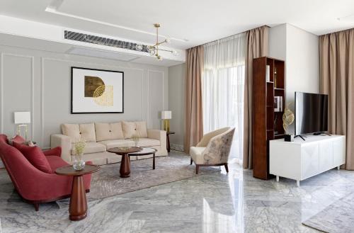 a living room with a couch and a tv at VESTA - Cairo Festival City Residence in Cairo