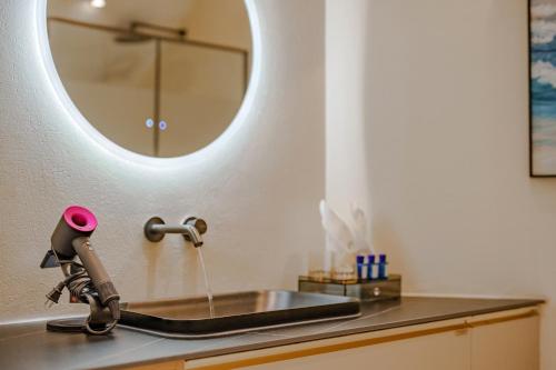 a bathroom sink with a faucet with water coming out at Dali Oriental Seaview Hotel -Dali Erhai in Dali