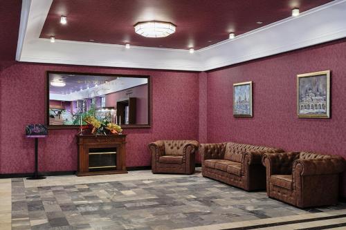 a waiting room with two chairs and a fireplace at Intourist Hotel in Velikiy Novgorod