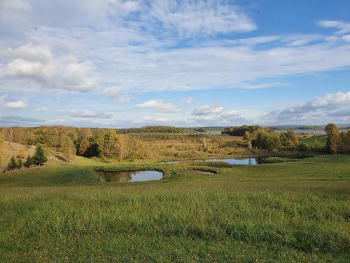 un campo de golf con dos estanques en un campo en Wyskok 1 - dom z widokiem, en Srokowo