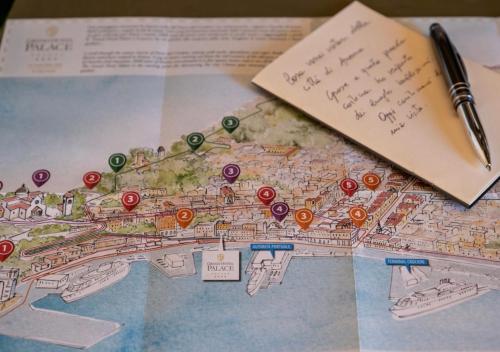 a map with a pen and a piece of paper at Grand Hotel Palace in Ancona
