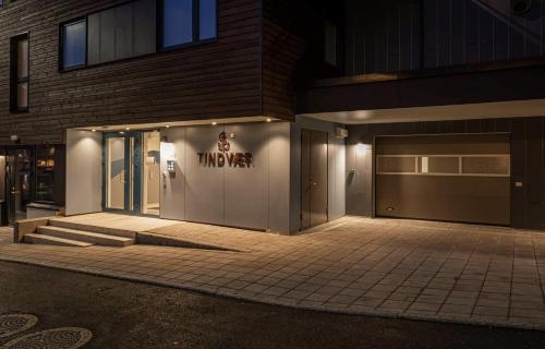 a building with a garage with a sign on it at Jaw dropping New Penthouse apt in Svolvær in Svolvær
