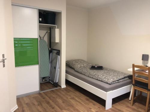 a small bedroom with a small bed in a room at GottwaldHaus-Freiberg-Apartment / B in Freiberg