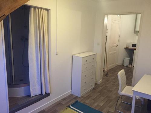 a bedroom with a dresser and a window and a desk at Studio hypercentre ralliement in Angers